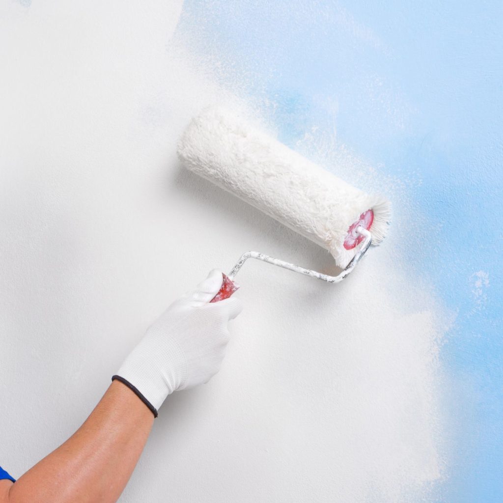 Paint roller painting a wall