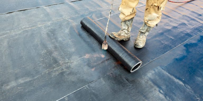 Man installing waterproof membrane